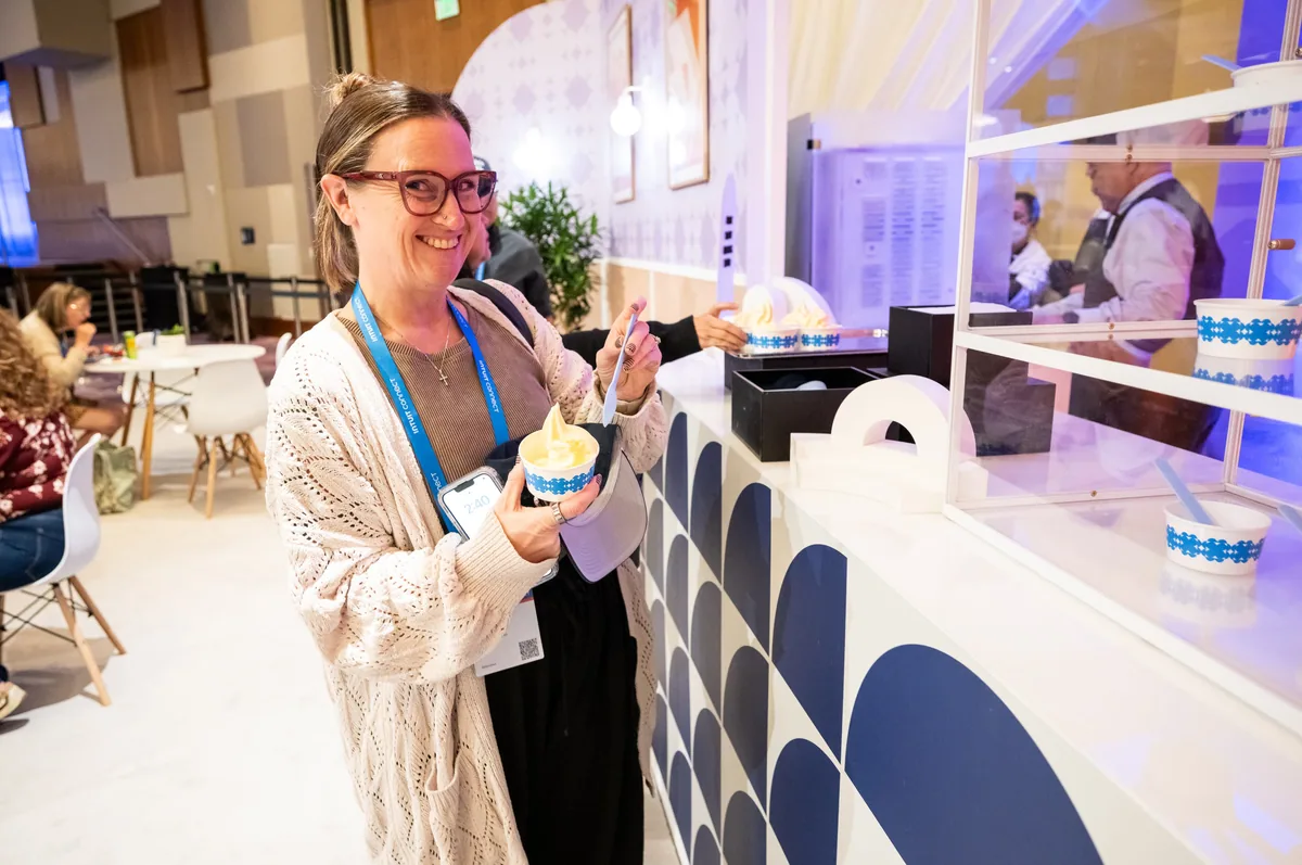 Attendee holding an ice cream cup in the lounge