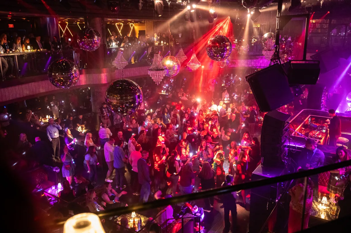 Crowd at the After Dark party under colored lights