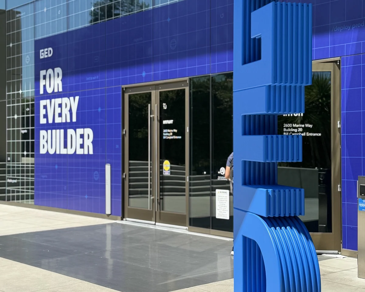 GED letterform beside a building wrapped in the For Every Builder graphic