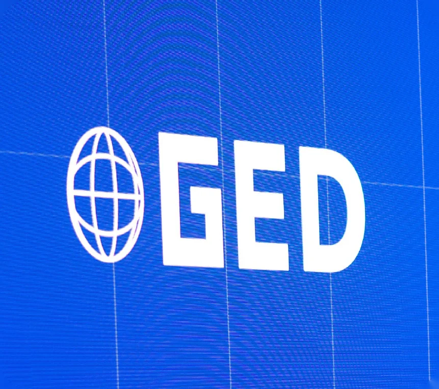 GED moments: the GED logo on screen, enamel pins, builders at work and a speaker on stage