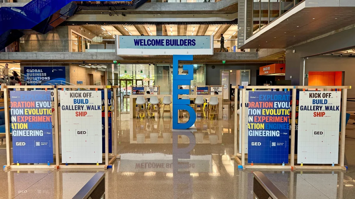 Welcome Builders entrance with kiosks and the GED letterform
