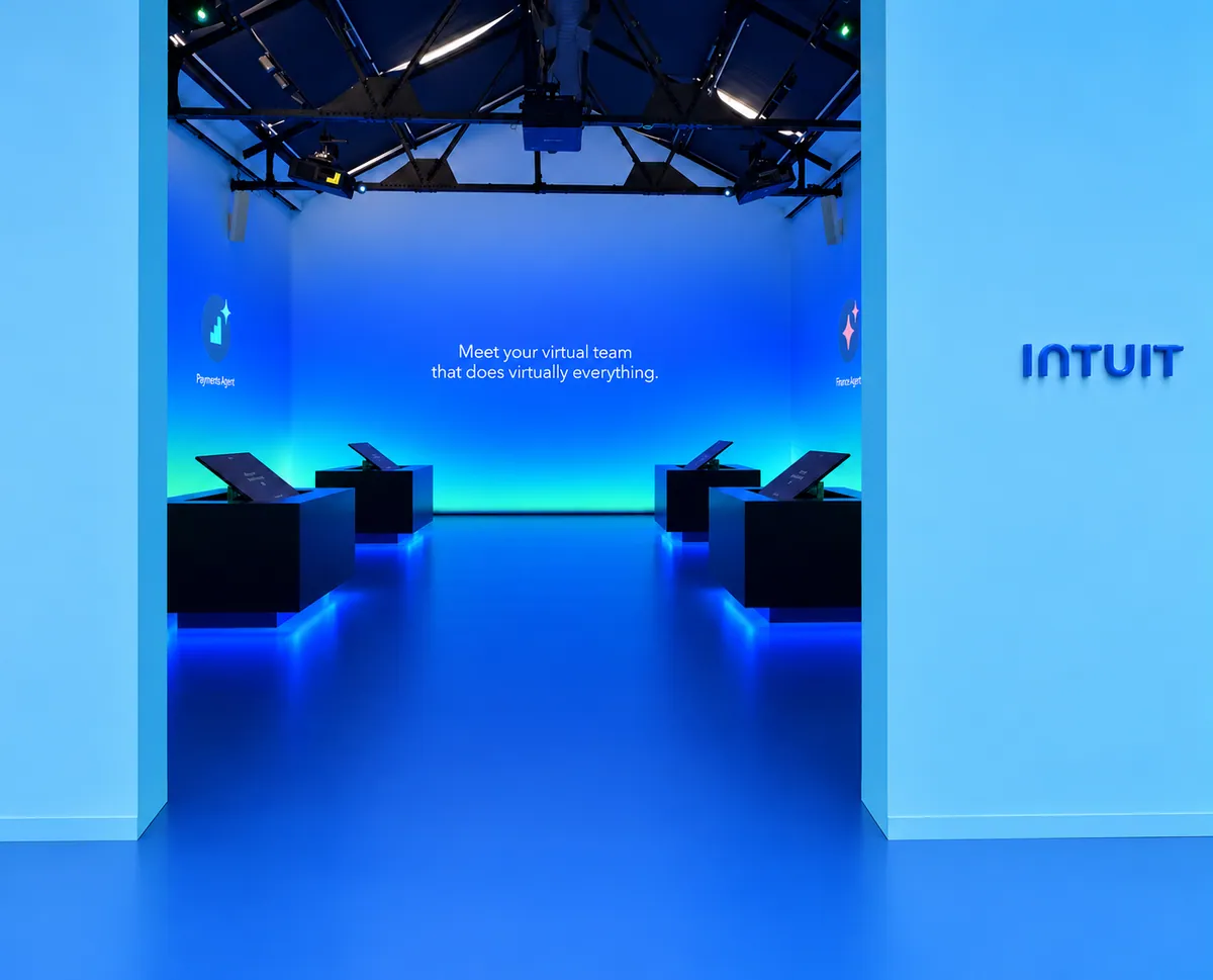 Gallery entry beside an Intuit logo, opening onto a blue demo room