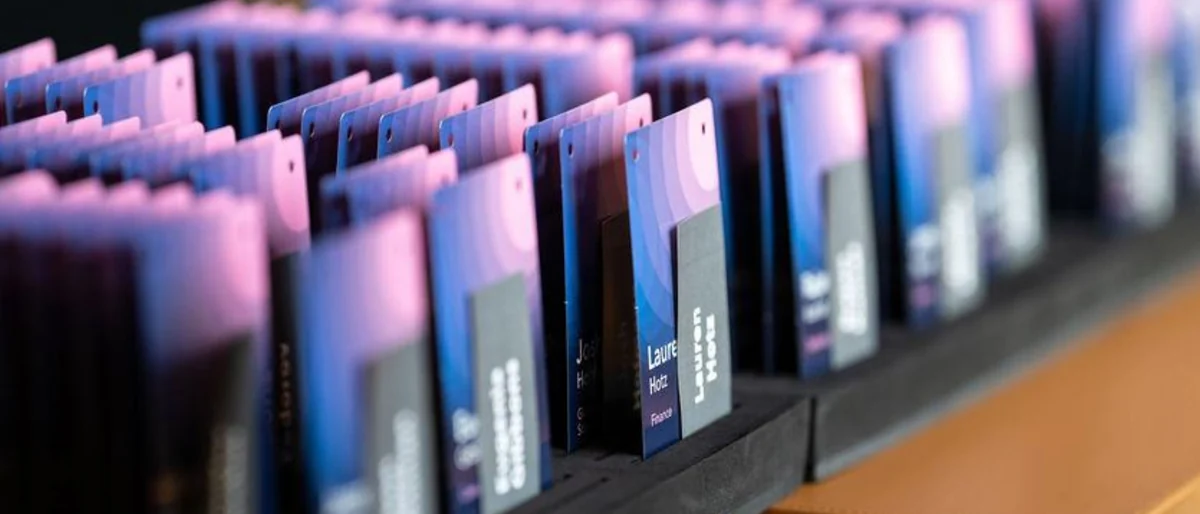 Printed name cards, a session sign, notebooks and the lounge with event signage