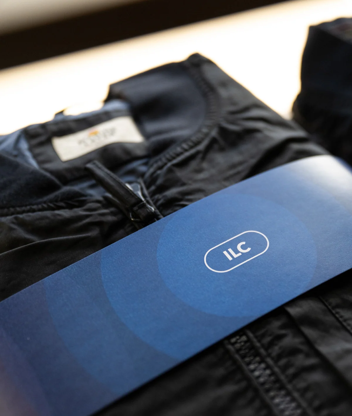 Branded jacket tag and notebook