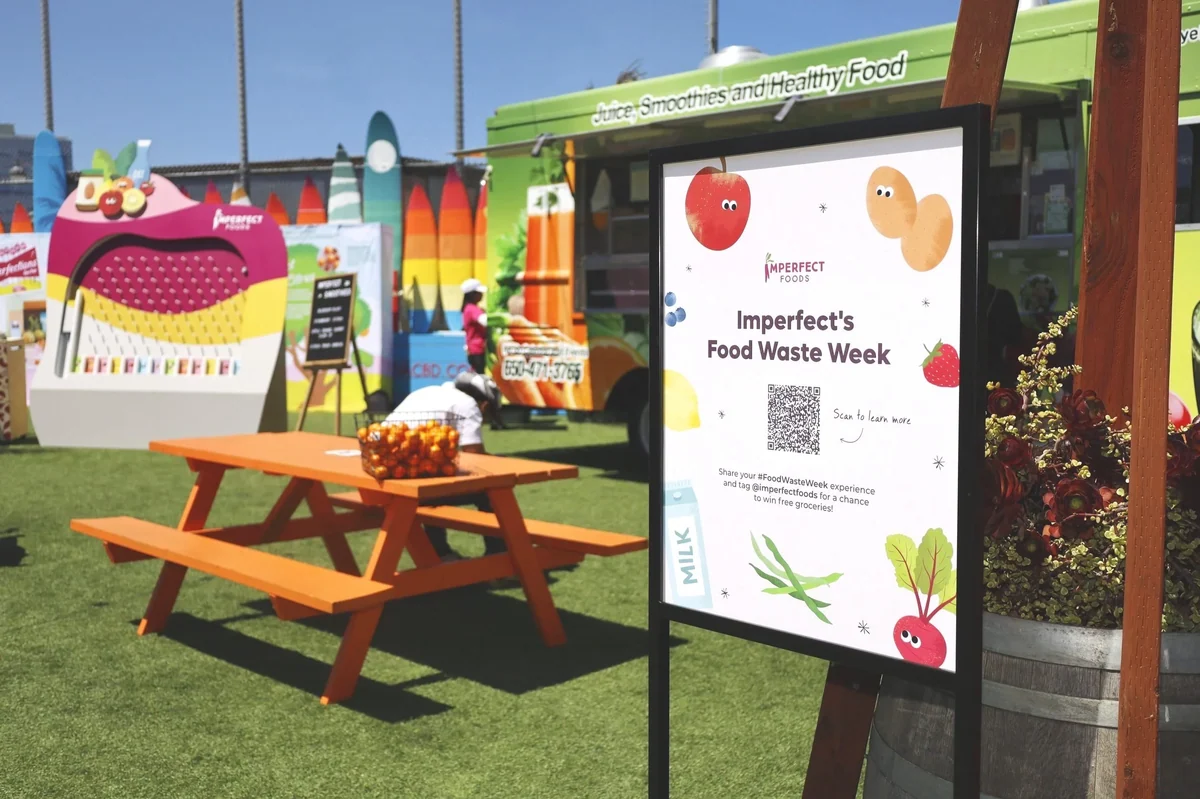 Food Waste Week signage beside an orange picnic table