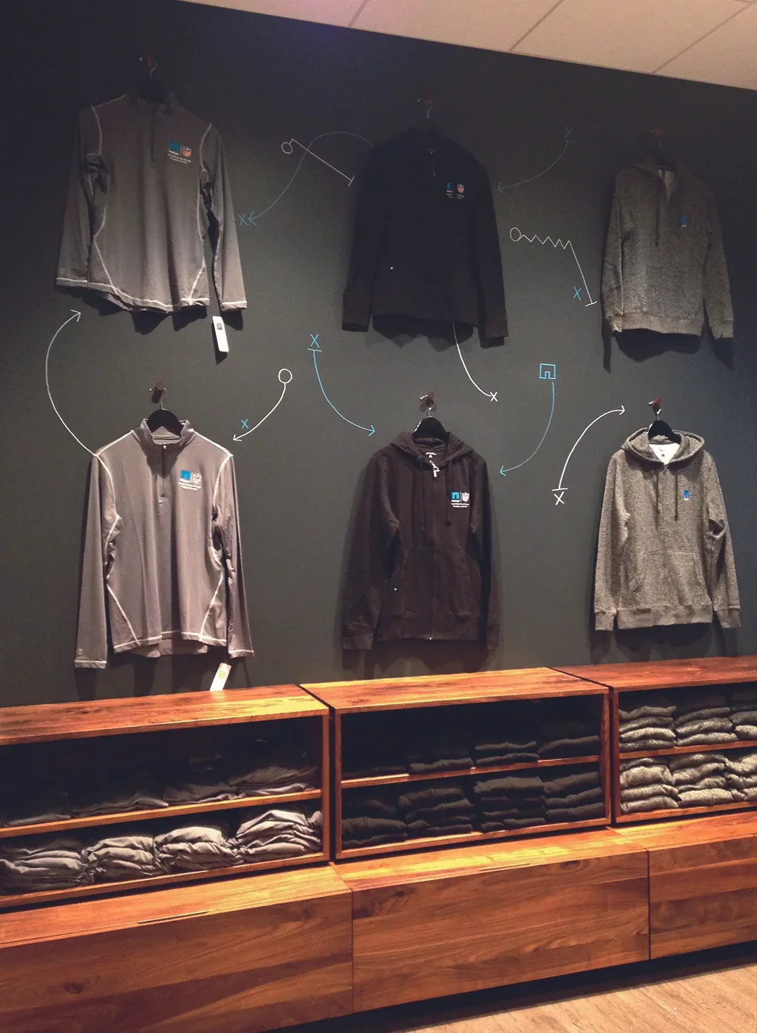 Chalkboard wall with hand-drawn graphics above apparel